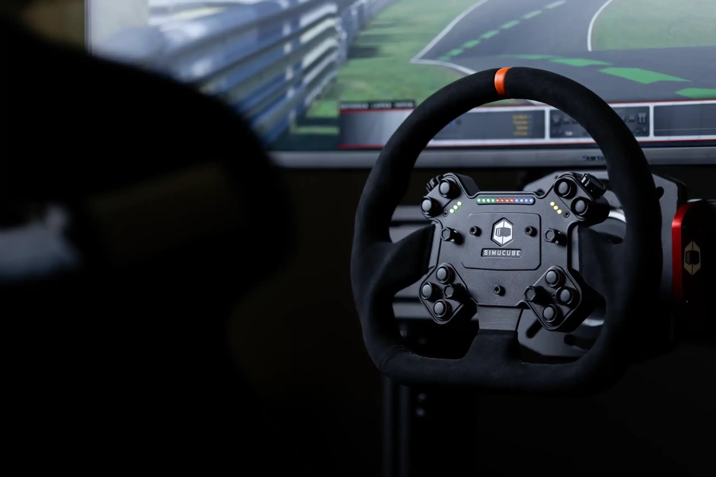 Racing simulator setup with steering wheel and racing game on screen, ideal for virtual driving and gaming enthusiasts.