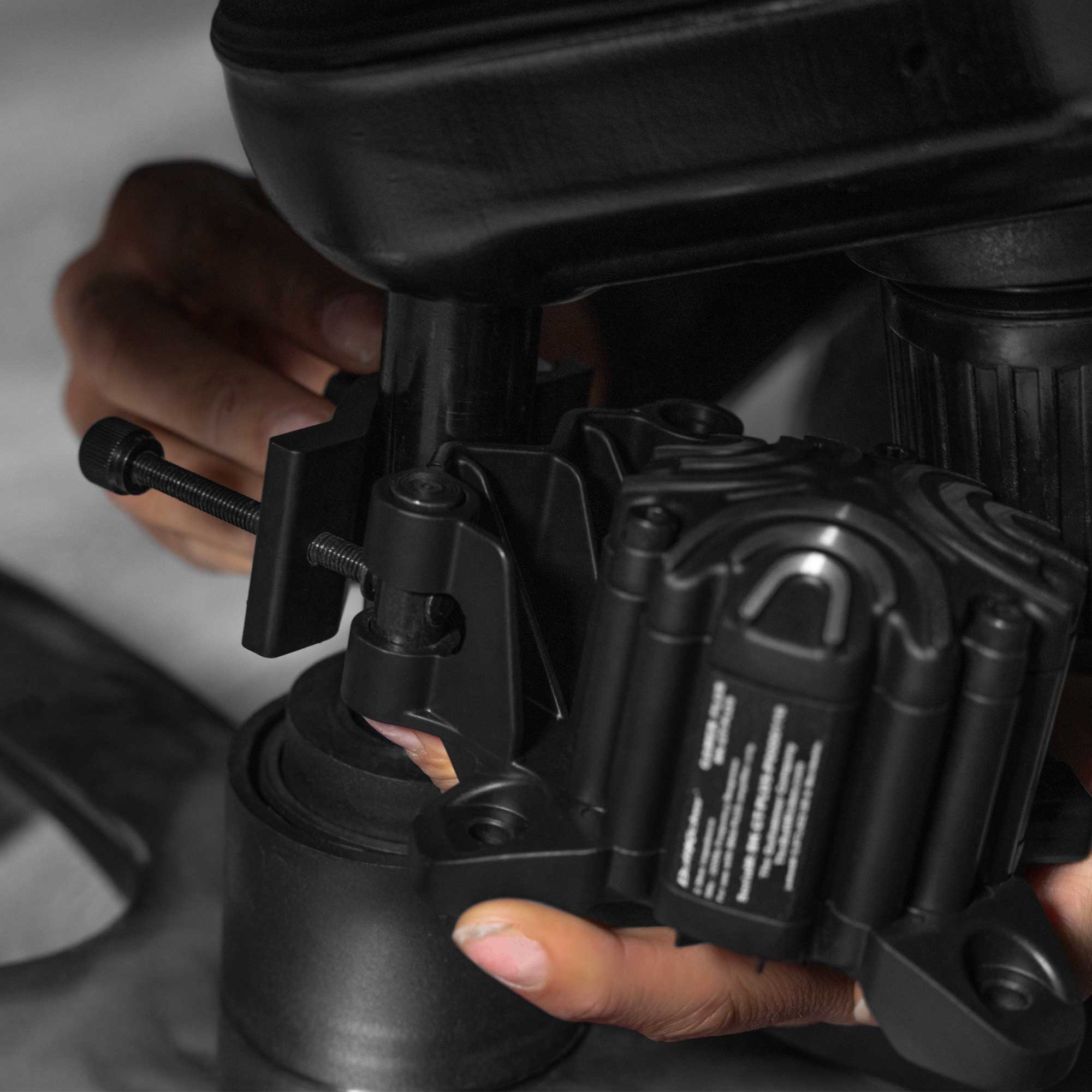ButtKicker Gamer Plus mounted to a gaming chair center post with the Universal Clamp