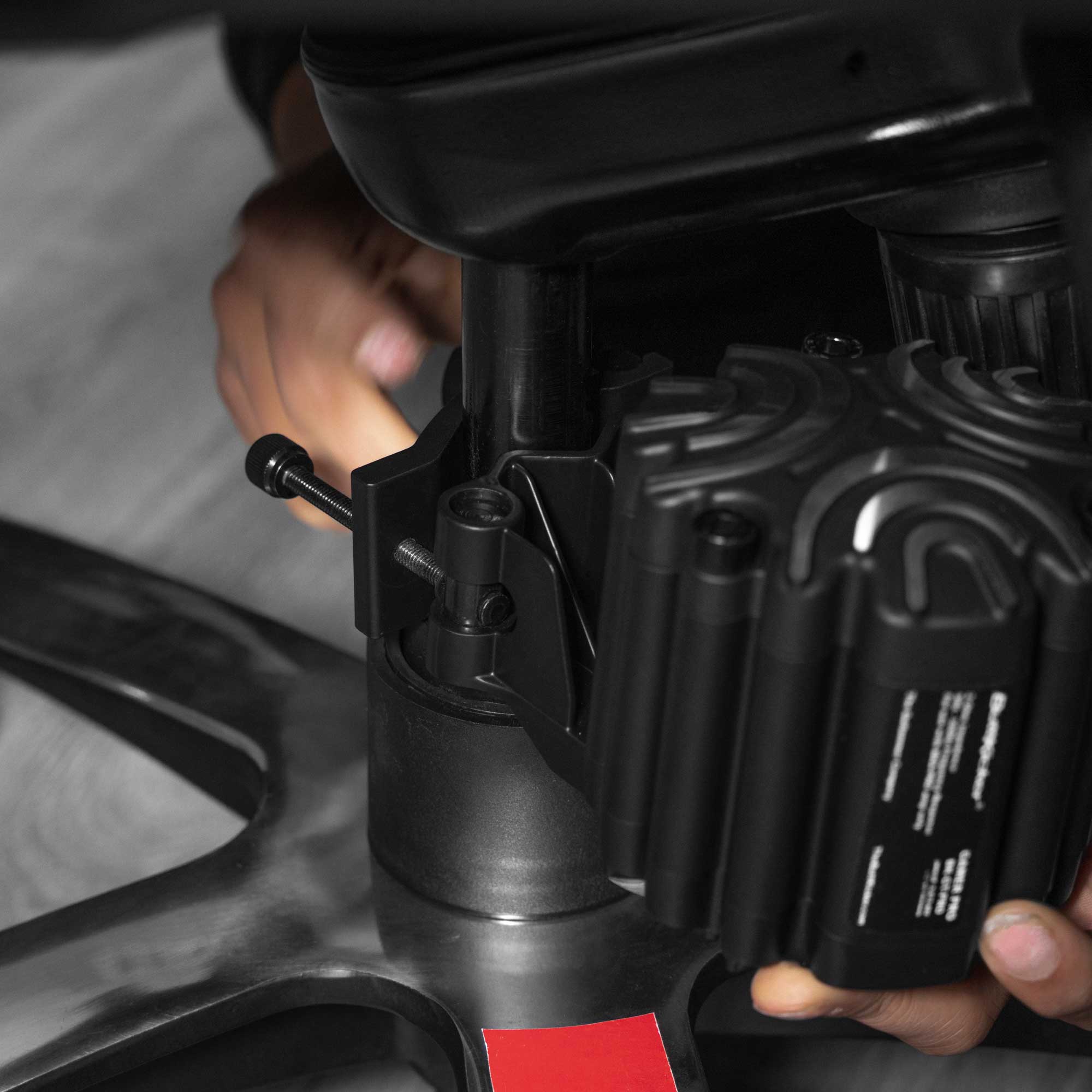 ButtKicker Gamer PRO universal clamp mounted on a gaming chair center post
