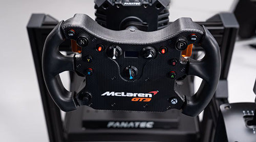 Close-up of a McLaren GT3 racing wheel by Fanatec, showcasing detailed controls and sleek design for enhanced racing simulation.