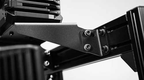 Close-up of a black metal bracket with bolts, part of a larger mechanical structure.