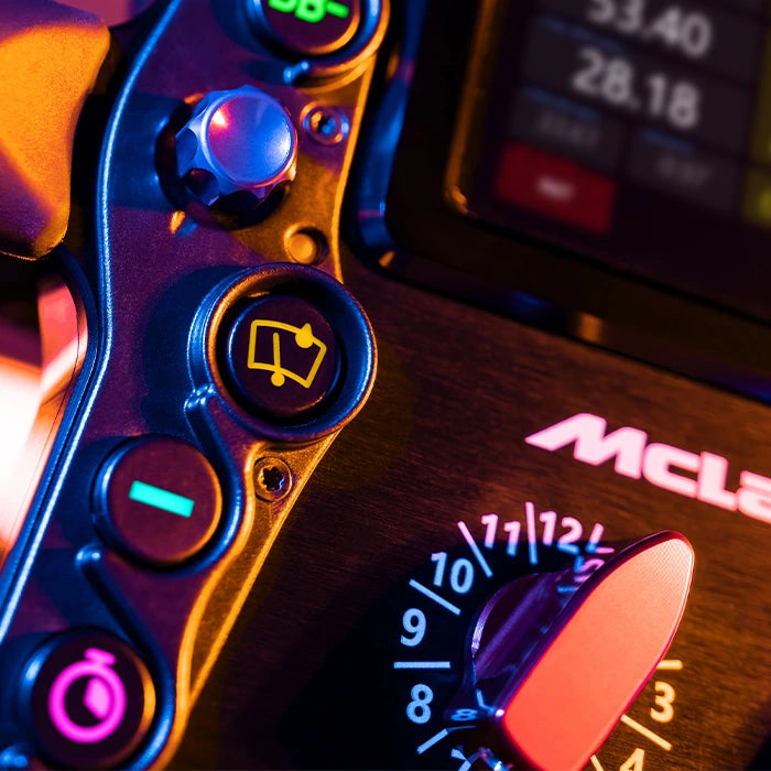 Close-up of McLaren car dashboard buttons with vibrant lighting and control indicators.