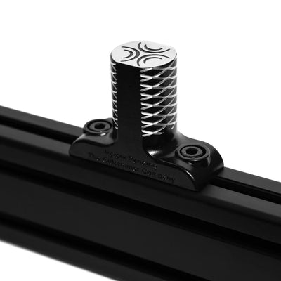 Close-up of ButtKicker Gamer PRO mounting clamp for sim rigs, ensuring easy installation on gaming seat frames.